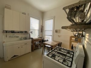 View of a kitchen with sink, table, and stove
