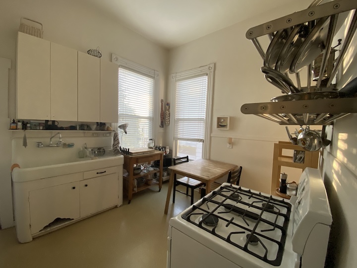 View of a kitchen with sink, table, and stove