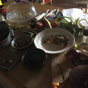 Kitchen counter with onion, bowls, magic markers and paper